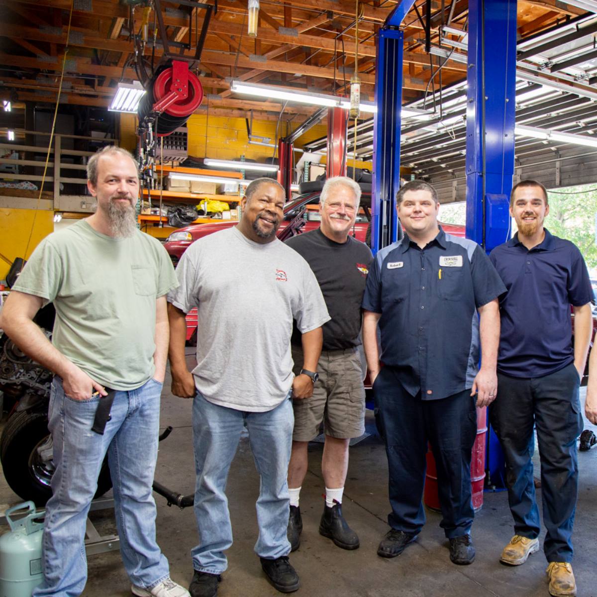 The Crown Hill Automotive team in the service bay at 9009 Holman Rd NW, Seattle